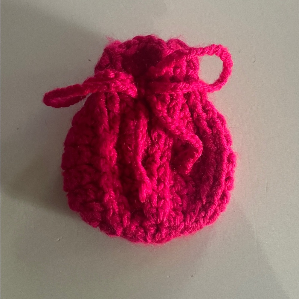 Miniature magenta-colored pouch
